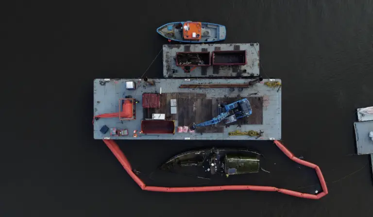 drone shot sunken boat removal from river dart, devon